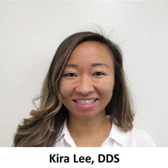 Kira lee, dds smiling in front of a white wall.