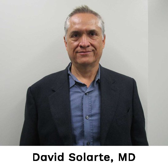 David solare, md, is standing in front of a wall.