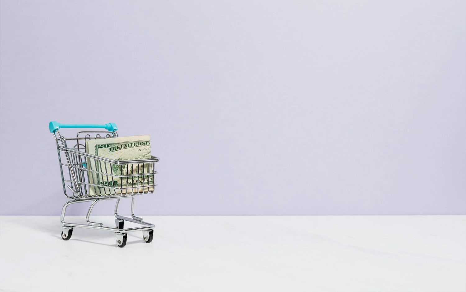 A shopping cart with money in it on a purple background.