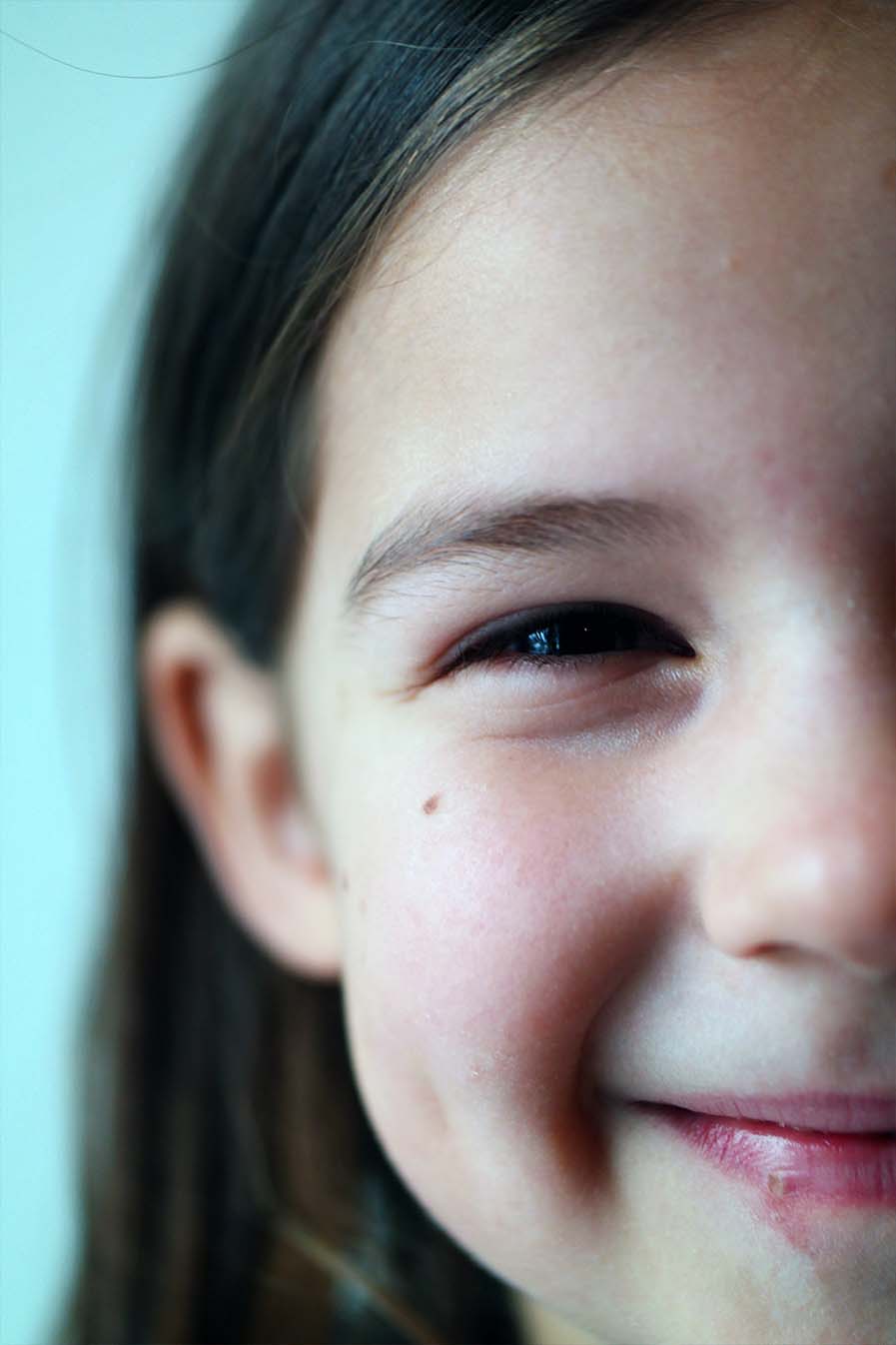 A close up of a young girl smiling.