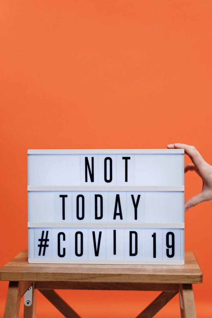 A person holding a sign that says not today covid19.