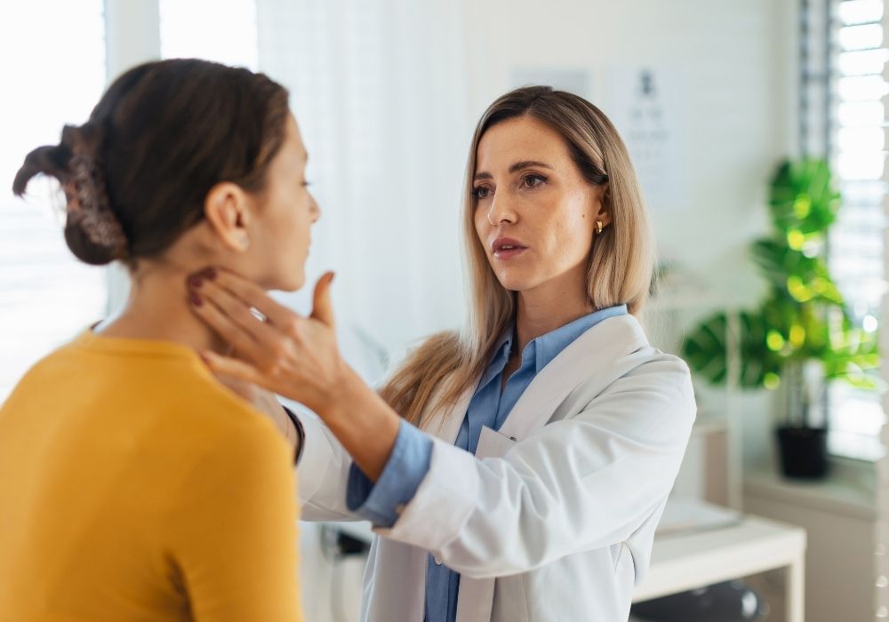 Doctor examining a patient's neck.