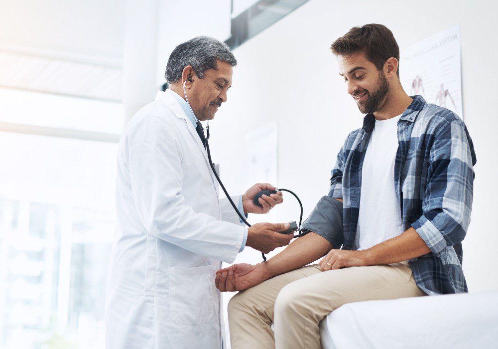 Healthcare, patient and doctor with blood pressure test.