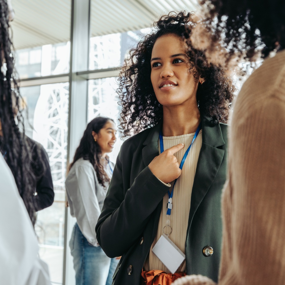 A lively conference scene showcasing diverse professionals immersed in interaction and exchange, highlighting networking and meaningful communication.