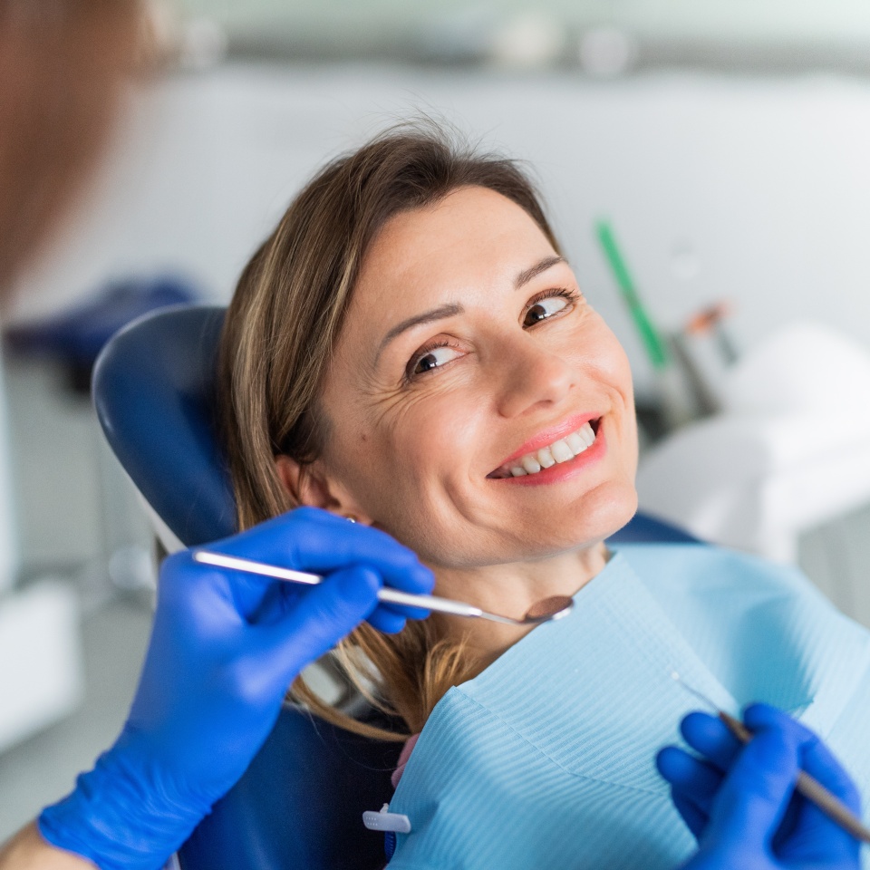 A woman has an annual dental check-up in dentist surgery.