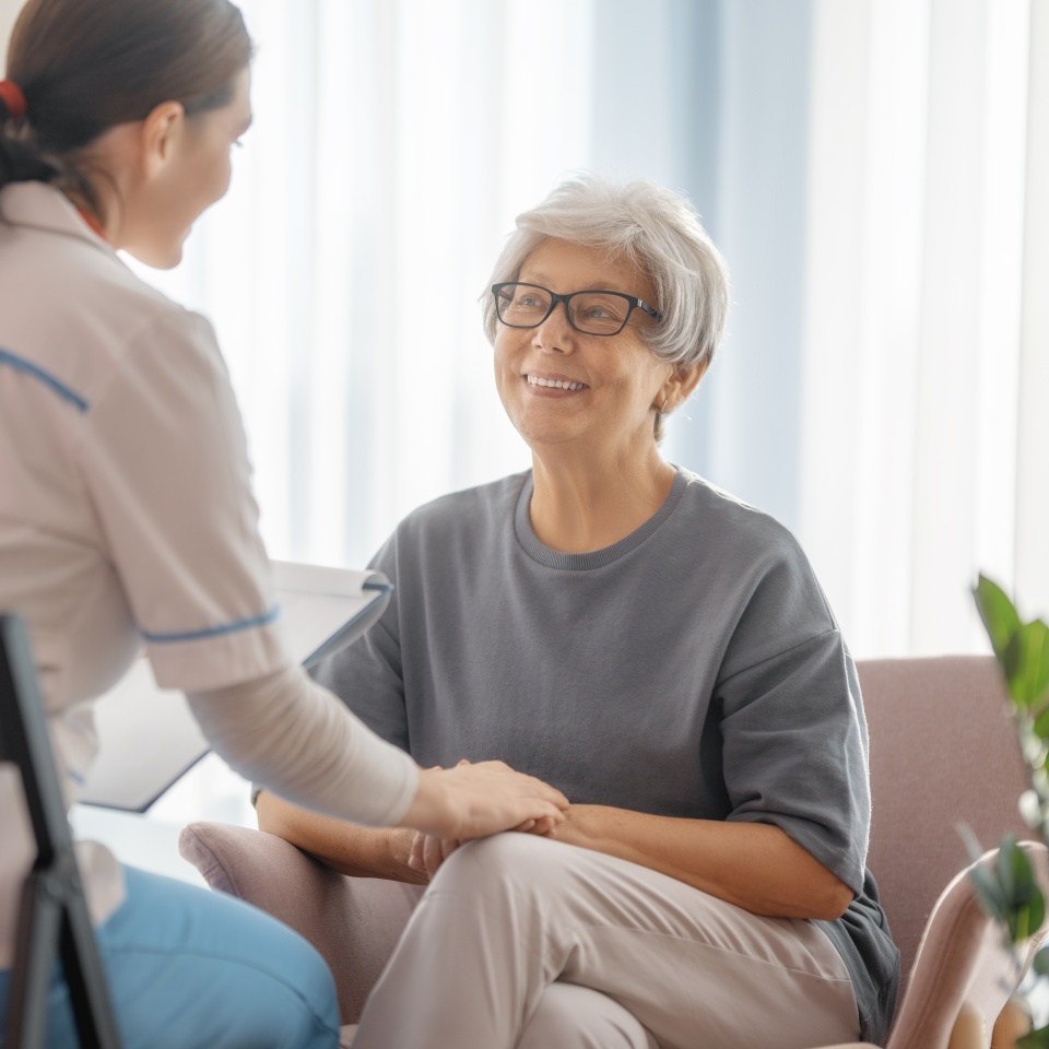 Female patient listening to a doctor in hospital.