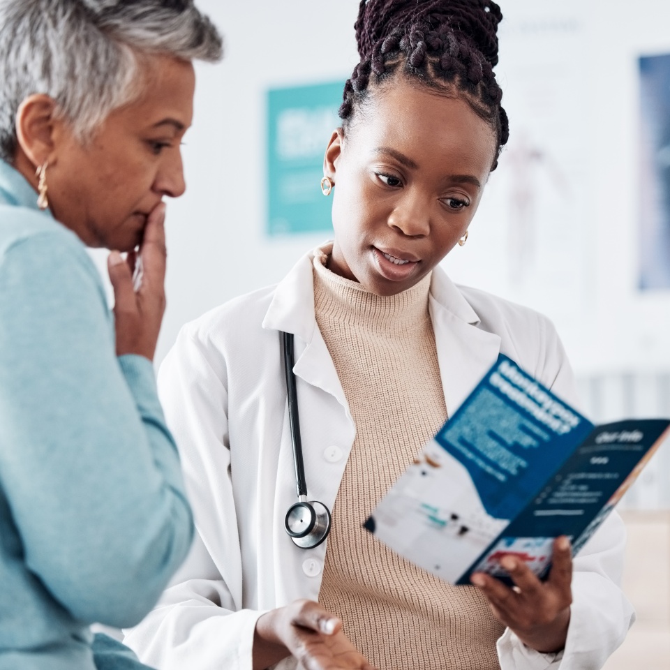 Brochure, consulting or doctor talking to patient for life insurance or healthcare services or medical data. Medicine, nurse helping or mature woman learning info on pamphlet in hospital for advice.