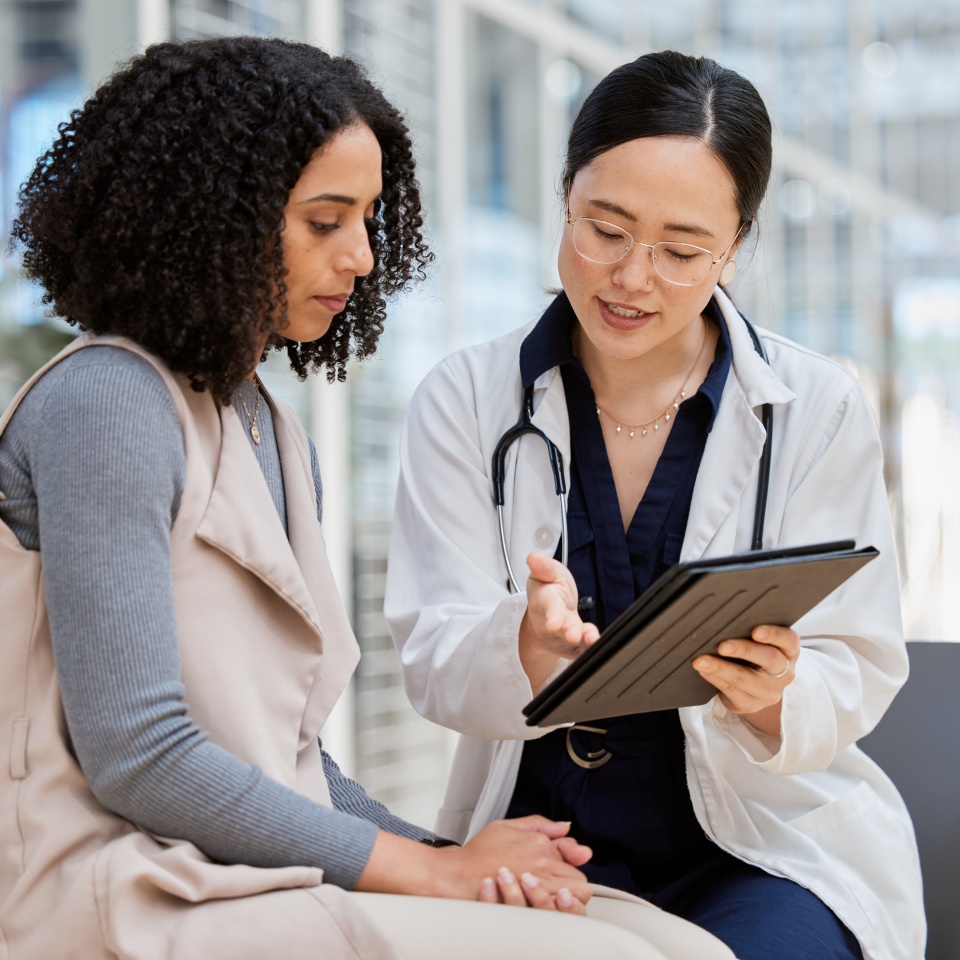 Doctor, woman patient and tablet for consulting with results, medical info and talk for healthcare with mockup space. Japanese medic, digital touchscreen or show video for surgery, wellness or advice.
