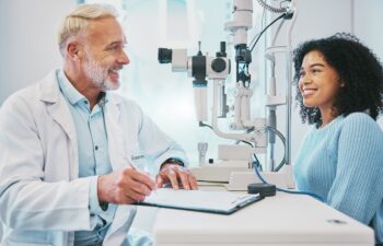 Eye exam, consulting and smile with doctor and black woman for healthcare, ophthalmology and medical. Glaucoma, laser and wellness with patient and optometrist in clinic for vision, checklist or help.